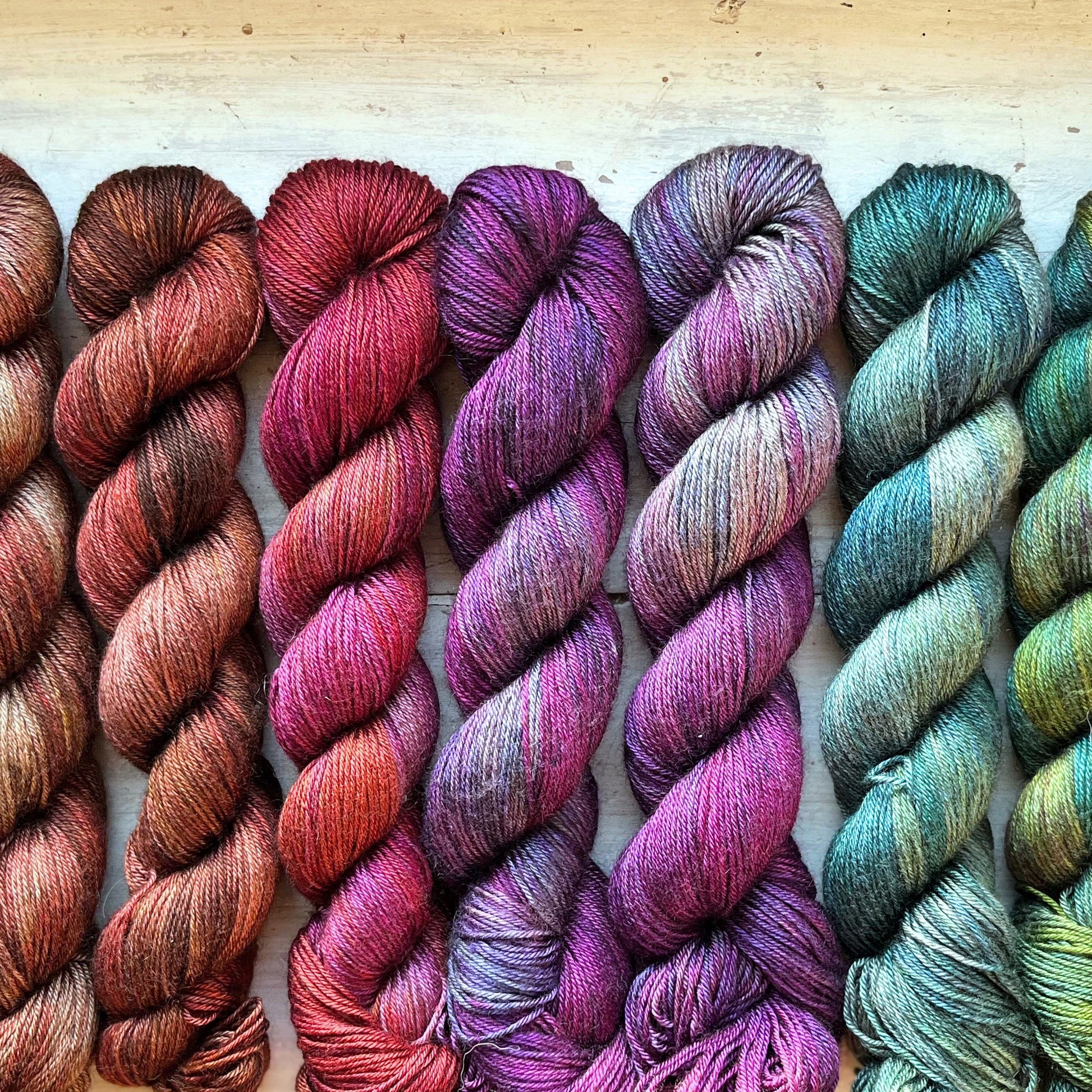 A skein of Equinox yarn weighing 50g in colorway Undyed which is globally the color grey